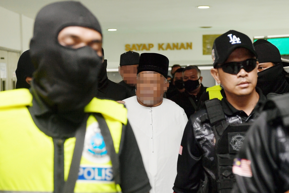 Senior executives of GISBH are seen under heavy police escort at the Shah Alam Court Complex on September 25, 2024 but have not been charged as yet. — Bernama pic