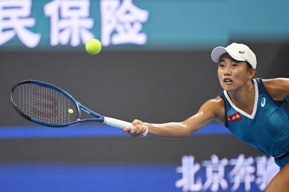 China’s Zhang Shuai hits a return to Belgium’s Greet Minnen during their women’s singles match at the China Open tennis tournament in Beijing on September 29, 2024. — AFP pic 