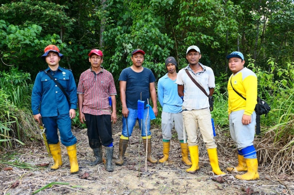 Sabah locals employed in the reforestation project that helps protect their natural heritage and provide sustainable livelihoods. — Picture courtesy of YSD