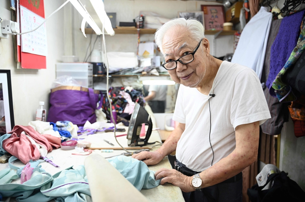 Cheongsam master Yan Kar-man is pictured in his small workshop in Kowloon, Hong Kong September 5, 2024. — AFP pic