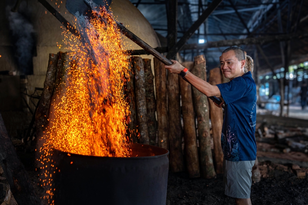 As a third-generation charcoal factory owner, Chuah Kee Yong, 53, said he is keen to preserve the legacy and history of Kuala Sepetang’s charcoal industry. — Bernama pic