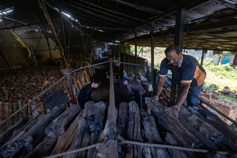 The factories comprise sheds with weathered, blackened wooden walls, furnaces known as ‘dapur’ or ‘gok’ and piles of mangrove wood. — Bernama pic