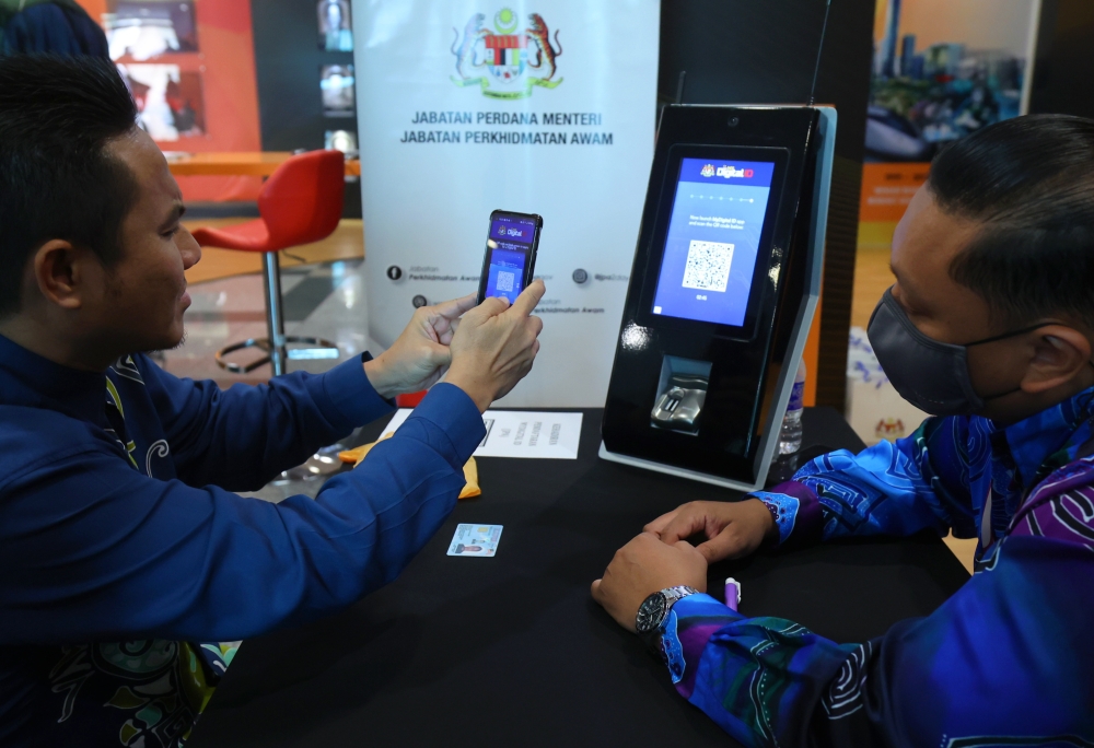 Public Service Department personnel sign into MyDigital ID at the PSD lobby in Putrajaya, December 14, 2023. — Bernama pic 