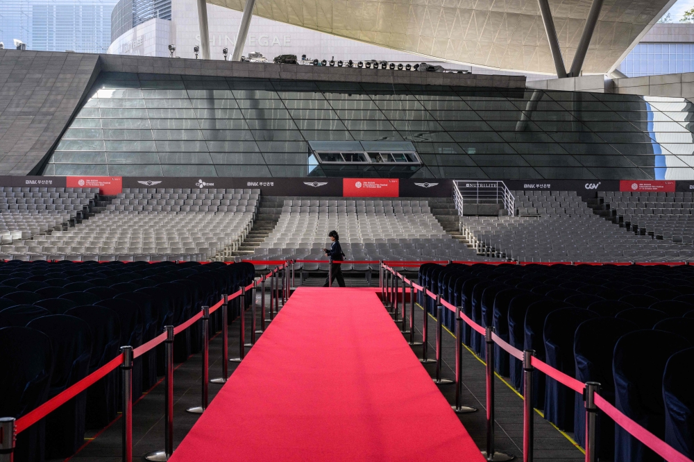 In this file photo taken on October 4, 2023, a woman walks past seats in the Busan Cinema Centre before the opening of the 28th Busan International Film Festival (BIFF) in Busan.  — AFP pic