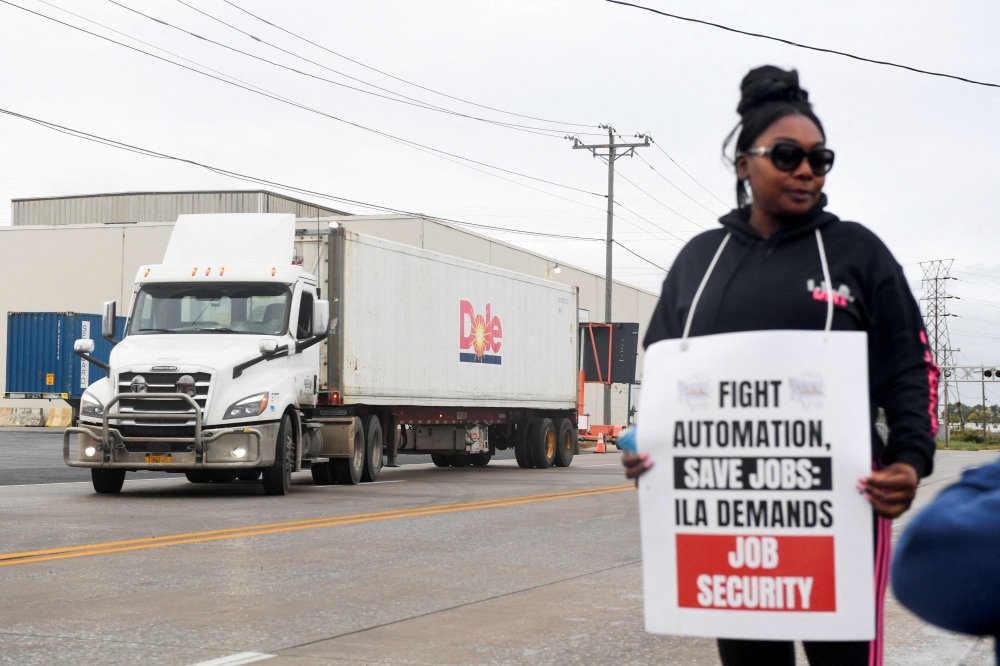 A dockworker demonstrates after a shipping port strike went into effect across the East Coast at the Port of Wilmington, Delaware October 1, 2024. — Reuters pic  