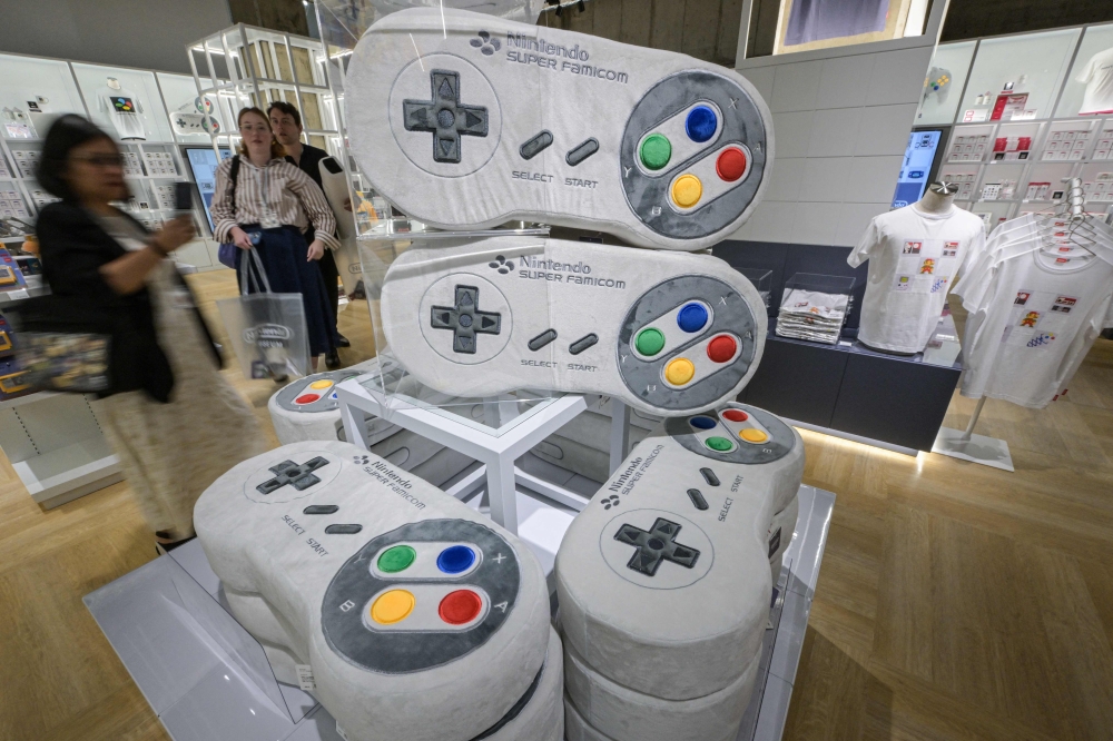 This photo taken on September 24, 2024 shows large console-shaped pillows in the gift shop during a media preview of the new Nintendo Museum, located inside a renovated old factory, in suburbs of Kyoto. — AFP pic