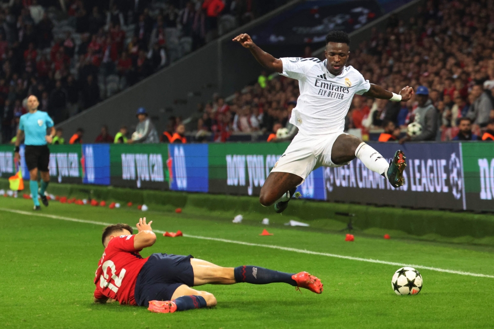 Real Madrid’s Vinicius Junior and Lille’s Thomas Meunier fight for the ball during their Uefa Champions League match in Villeneuve-d’Ascq October 2, 2024. — AFP pic