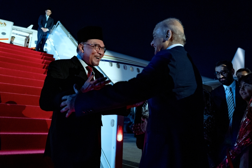 Malaysian Prime Minister Datuk Seri Anwar Ibrahim (left) is greeted by his Pakistani counterpart Shehbaz Sharif at the Nur Khan Air Base in Rawalpindi upon touchdown in Pakistan for an official three-day visit on October 2, 2024. — Bernama pic