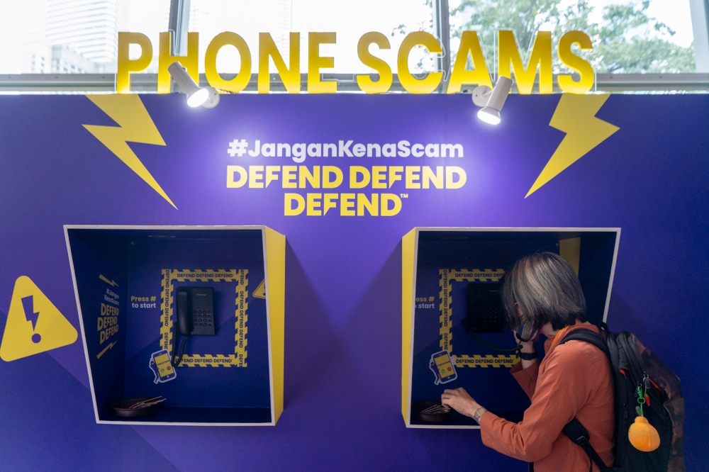 A file photograph shows an exhibit at the National Scam Awareness Campaign at Kuala Lumpur Convention Centre on October 3, 2023. According to the State of Scam Report 2024, 70 per cent of scam victims did not report their cases to the authorities, representing a five per cent drop from the previous year. — Picture by Shafwan Zaidon