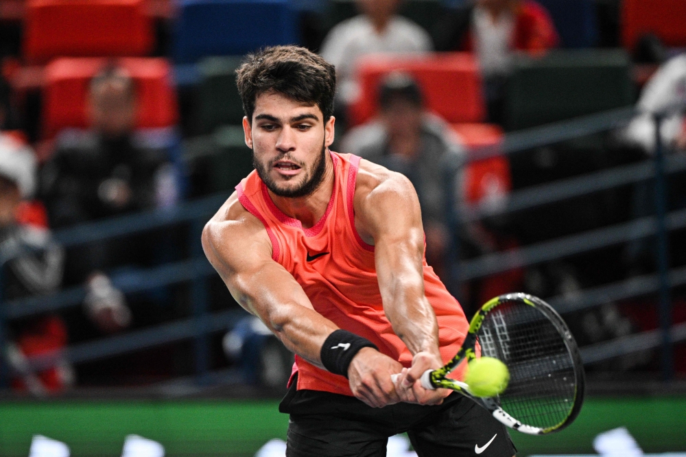 Spain's Carlos Alcaraz hits a return to China's Shang Juncheng during their men's singles match at the Shanghai Masters tennis tournament in Shanghai October 5, 2024. — AFP pic