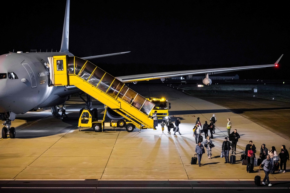 Dutch, Belgian, Finnish and Irish nationals deplace from an Airbus A330-243MRRTT Netherlands Royal Air Force transportation plane at the Eindhoven Military Air Base after being evacuated  from Lebanon, in Eindhoven on October 4, 2024. — Rob Engelaar/ANP/AFP pic