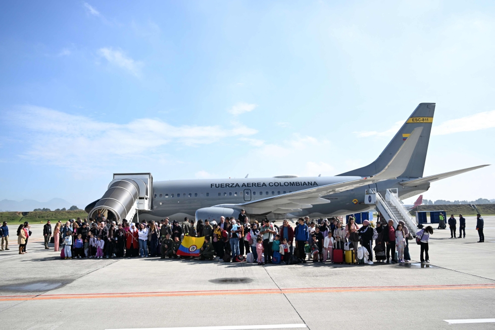 Passengers pose for a picture after disembarking a Colombian government evacuation flight from Lebanon at El Dorado International Airport in Bogota October 3, 2024. — AFP pic