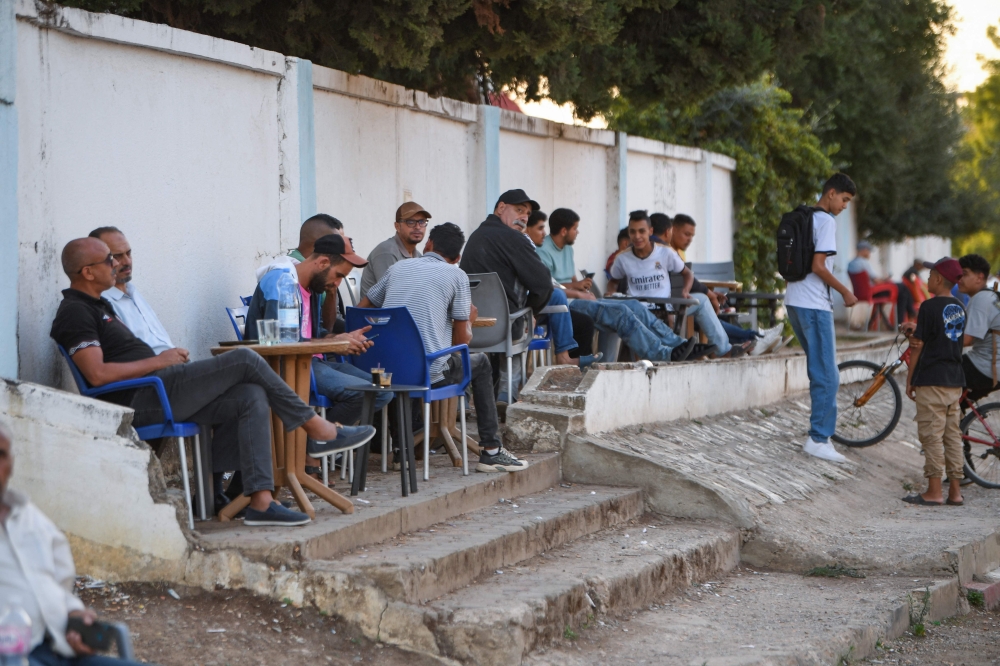 Residents sit at a street coffee shop in the center of north-western Tunisia's Fernana town on September 25, 2024. — AFP pic