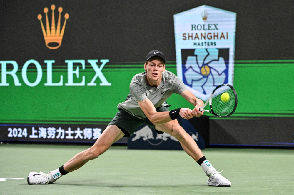 Italy's Jannik Sinner hits a return to Japan's Taro Daniel during their men's singles match at the Shanghai Masters tennis tournament in Shanghai October 5, 2024. — AFP pic