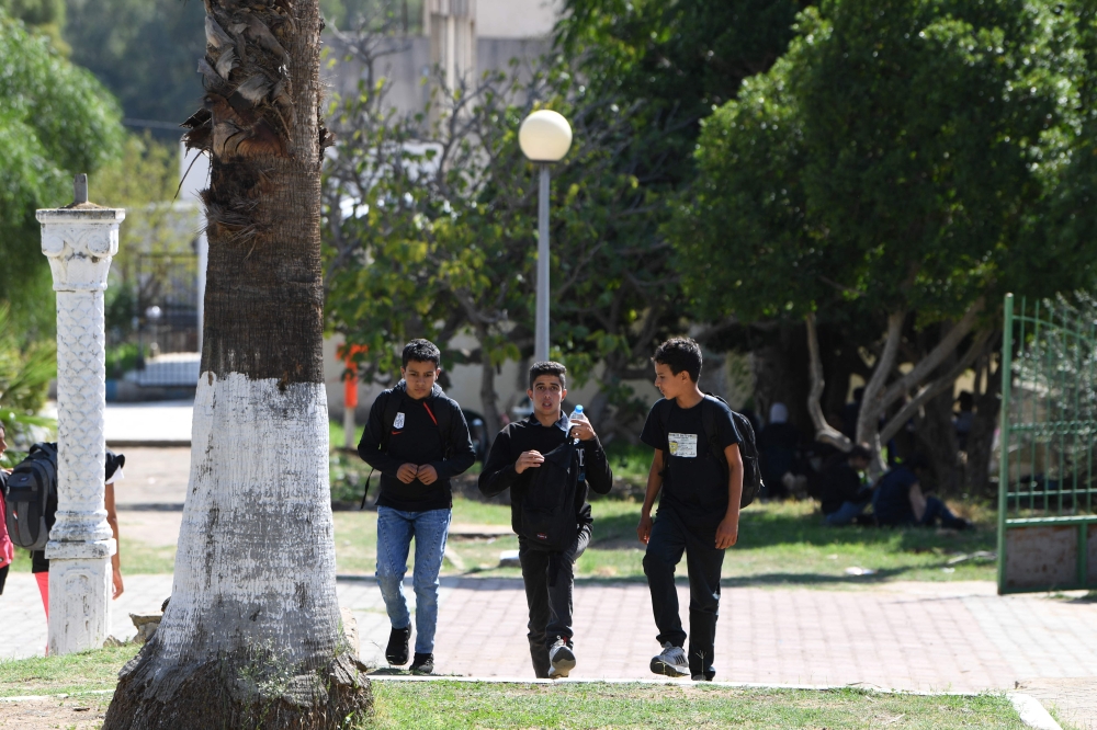  Schoolboys walk back home through a public garden in the centre of north-western Tunisia’s Fernana town September 25, 2024. — AFP pic