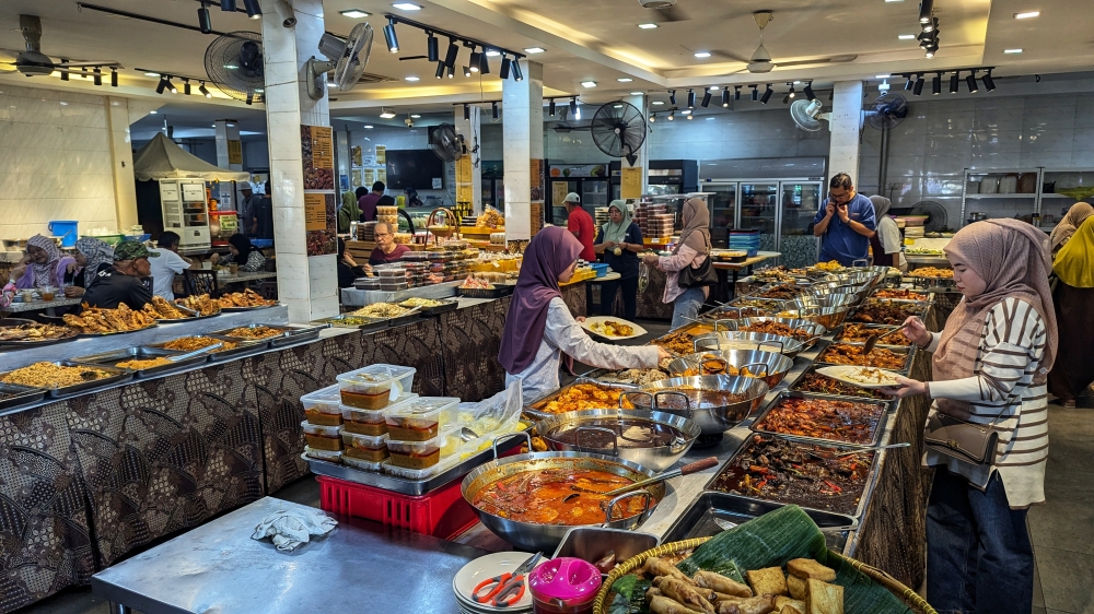 Just a small snapshot of the massive spread at Restoran Hatinie. — Picture by Ethan Lau