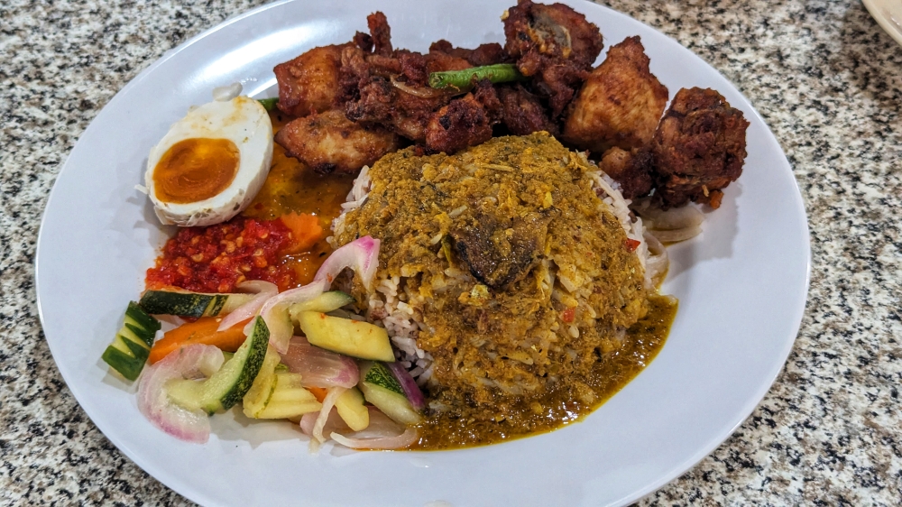 ‘Nasi dagang’ with ‘ayam goreng kunyit’. You can mix and match however you like. — Picture by Ethan Lau