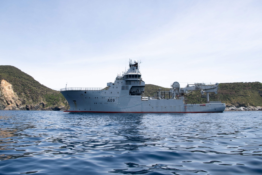 A handout photo taken on December 1, 2023 and obtained from the New Zealand Defence Force on October 6, 2024 shows the Royal New Zealand Navy ship the HMNZS Manawanui in a bay in the Three Kings Islands. New Zealand said today it had rescued all 75 sailors from a navy vessel that ran aground and sank off Samoa while conducting a reef survey. — New Zealand Defence Force handout pic via AFP