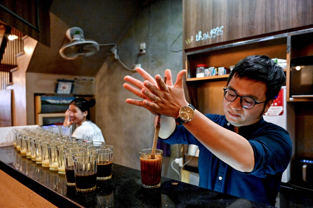 This photo taken on August 21, 2024 shows owner Nguyen Duc Hieu making a coffee at his cafe in Hanoi. Running a cafe is not a career that many of Vietnam's growing group of ambitious middle-class parents would choose for their children. — AFP pic