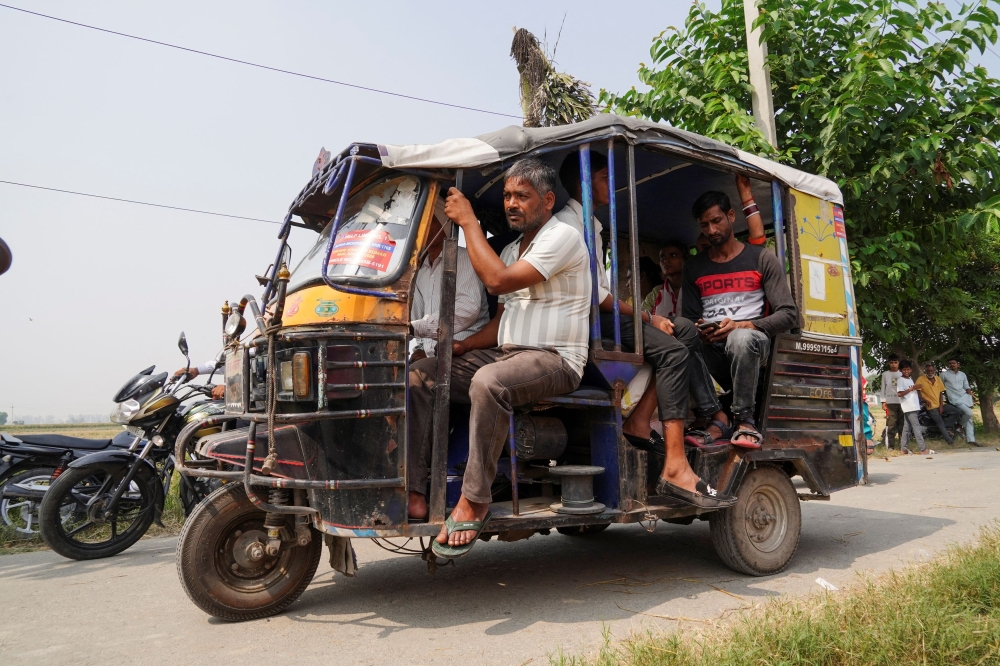 People travel in a rickshaw on their way to a polling station to vote during the state assembly elections, in Karnal, in the northern state of Haryana, India October 5, 2024. — Reuters pic  