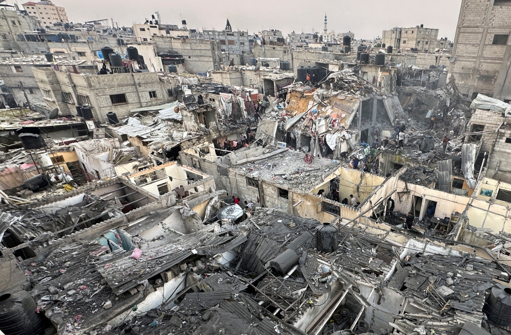 People search through the rubble of damaged buildings following an Israeli air strike on Palestinian houses, amid the ongoing conflict between Israel and the Palestinian Islamist group Hamas, in Rafah in the southern Gaza Strip December 12, 2023. — Reuters pic