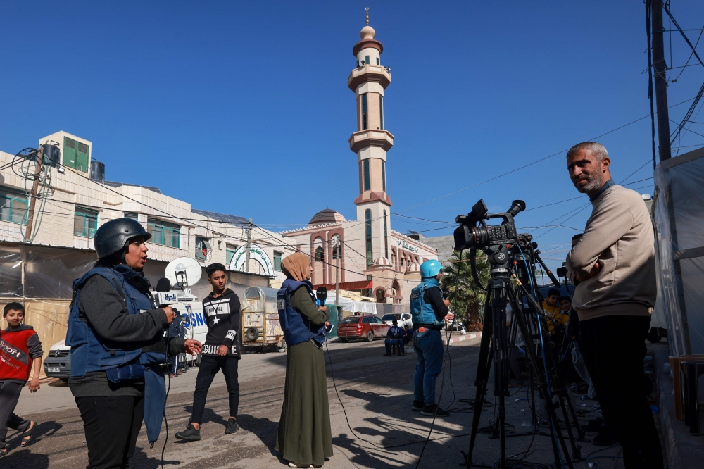 File picture of journalists working on a street in Rafah on the southern Gaza Strip on December 11, 2023, amid continuing battles between Israel and Hamas. — AFP pic