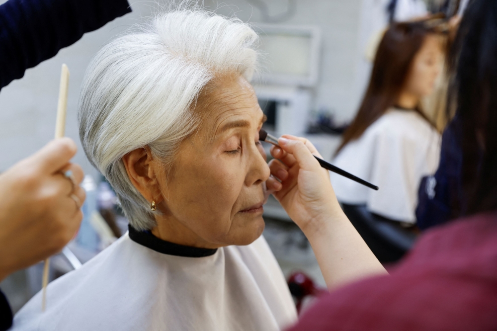 Choi Soon-hwa gets her makeup done in the makeup room before appearing on the morning news in Seoul October 4, 2024. — Reuters pic