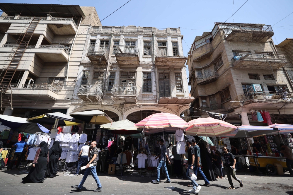 People shop at a market on Rashid Street set up in front of historic buildings in central Baghdad September 10, 2024. — AFP pic