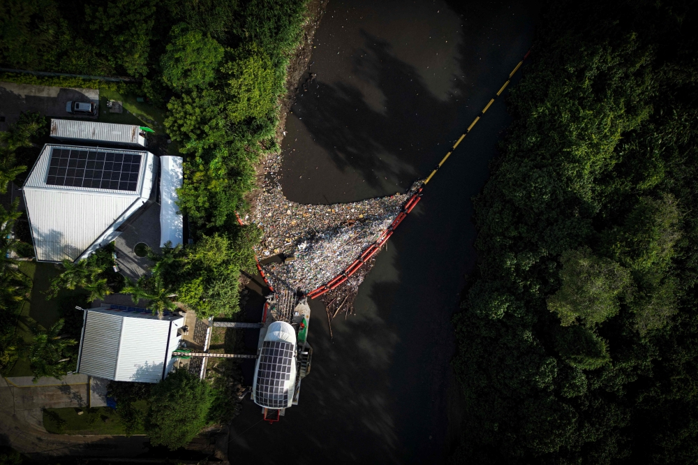 Aerial view of ‘Wanda,’ a gigantic hydraulic and solar-powered machine that collects garbage from the Juan Diaz River to prevent it from reaching the sea in Panama City, taken on October 1, 2024. — AFP pic