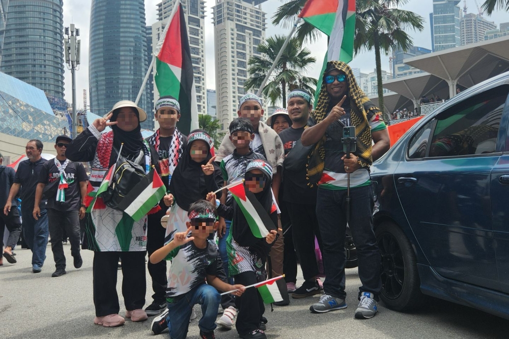 Rafiq, 36, drove from Kuantan with his family and will be returning home after the rally is done. — Picture by Arif Zikri