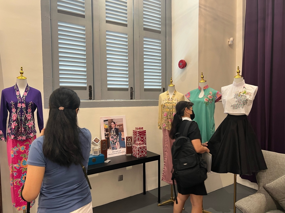 Visitors checking out Kenny Loh’s contemporary take on nyonya kebaya at the “Road to Unesco- Nyonya Sarong Kebaya exhibition in Penang on October 12, 2024. — Picture by Opalyn Mok