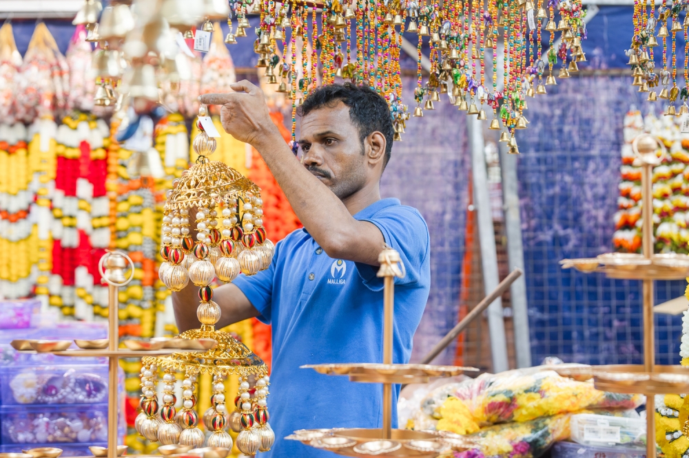 A vendor arranges traditional Deepavali decor at his stall in Brickfields, Kuala Lumpur October 2, 2024. — Picture By Raymond Manuel