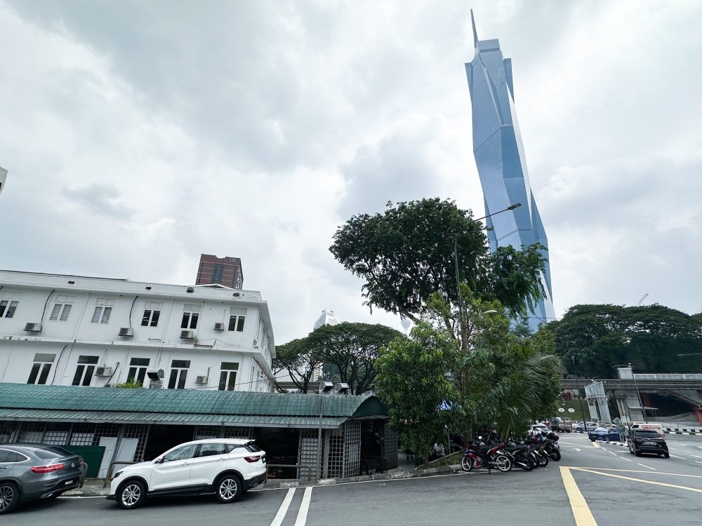 The big tree that sheltered them for so many years may be gone but now they have Merdeka 118 towering above. — Pictures by Lee Khang Yi