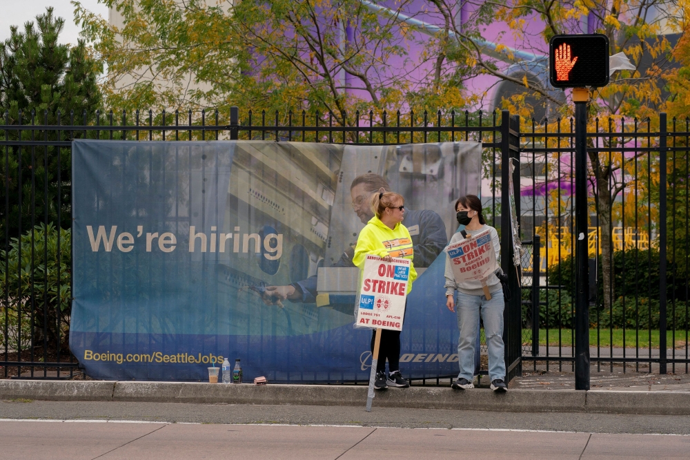 Boeing factory workers gather on a picket line near the entrance to a Boeing production facility in Renton, Washington October 11, 2024. — Reuters pic  