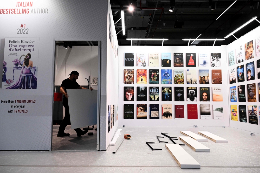 An employee prepares a stand into a pavilion of the Frankfurt book fair on October 14, 2024, prior to the opening of the world's biggest book fair in Frankfurt am Main. — AFP pic