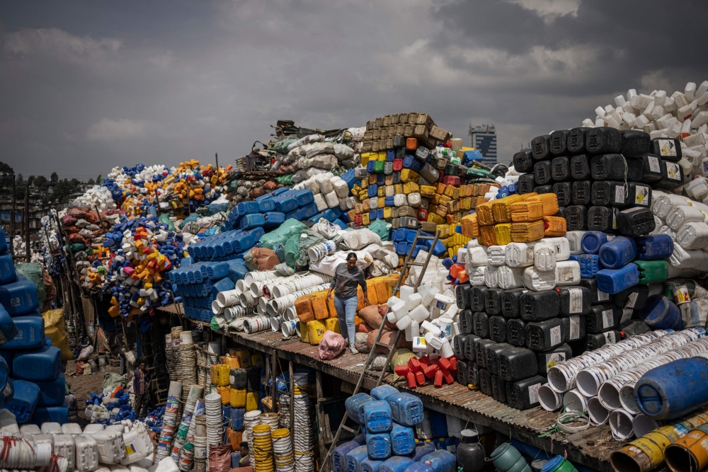  A woman walks among piles of plastic collected to be resold at the historical Merkato district of Addis Ababa on October 1, 2024. — AFP pic