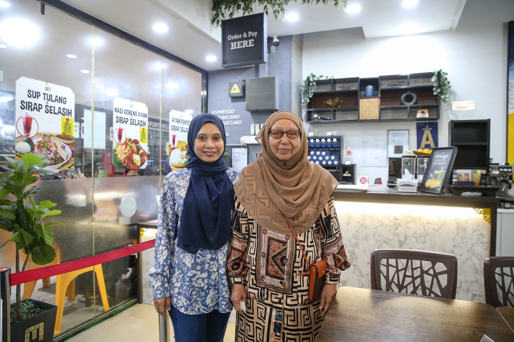 Hazwani Wahab (left) and her mother Som Ahmad pose for a photograph at their restaurant at Pertama Complex in Kuala Lumpur on October 15, 2024. — Picture by Yusof Mat Isa