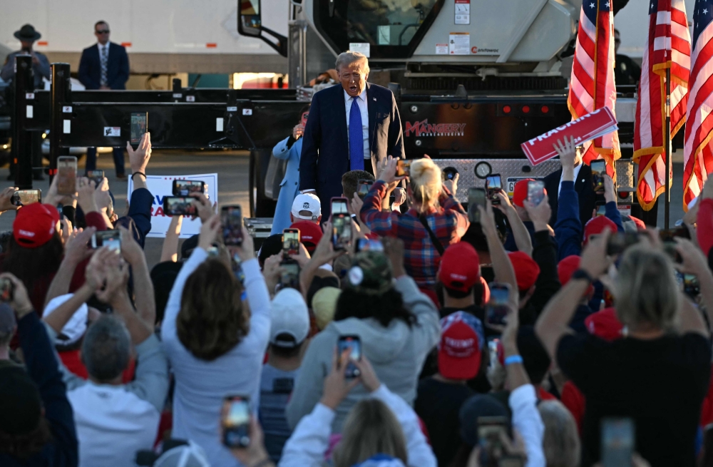 Former US President and Republican presidential candidate Donald Trump arrives to speak during a campaign rally at Arnold Palmer Regional Airport in Latrobe, Pennsylvania yesterday. — AFP pic