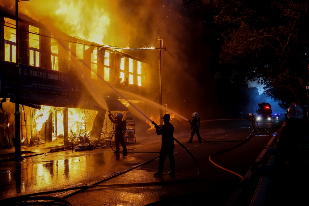 Firefighters work to extinguish the fire that destroyed three pre-war shophouses along Jalan Besar in Kuantan, on Oct 19, 2024. — Bernama pic