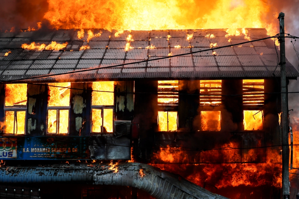 A fire burns among three pre-war shophouses along Jalan Besar in Kuantan, on Oct 19, 2024. — Bernama pic