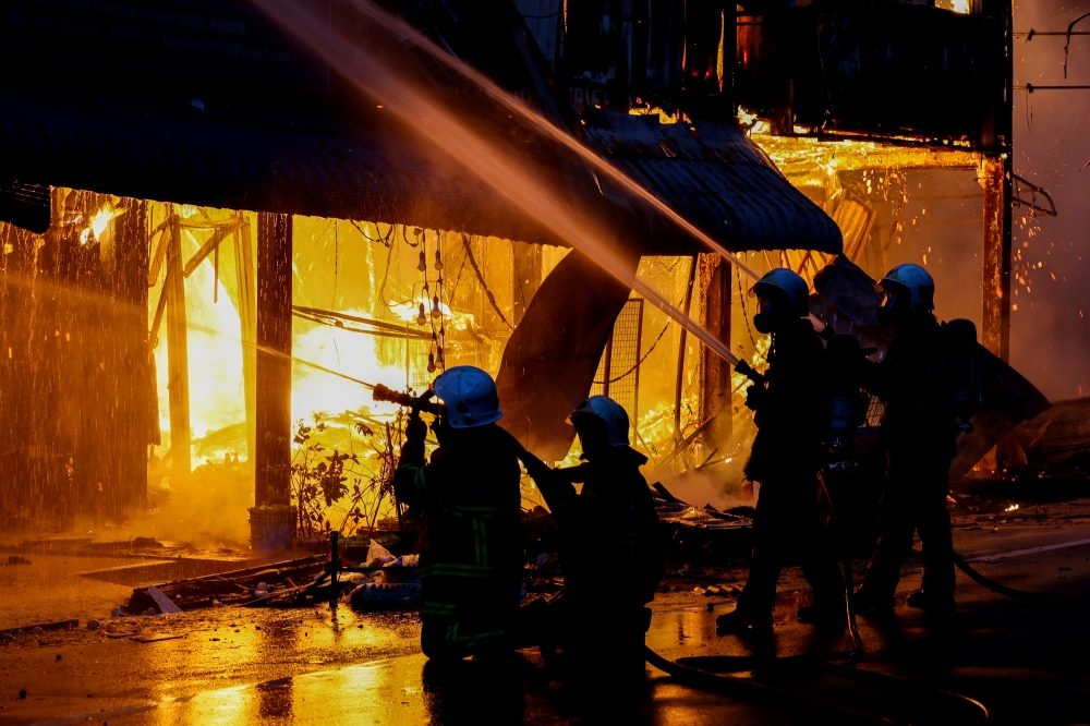 Firefighters work to extinguish the fire that destroyed three pre-war shophouses along Jalan Besar in Kuantan, on Oct 19, 2024. — Bernama pic