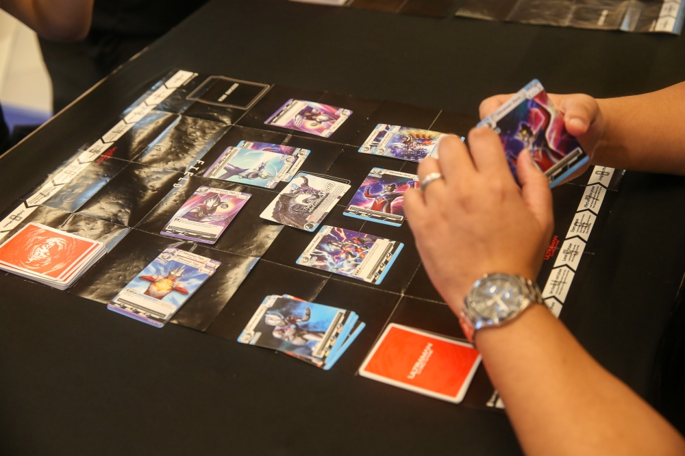 The event features interactive demos, including an Ultraman card game. — Photo by Choo Choy May