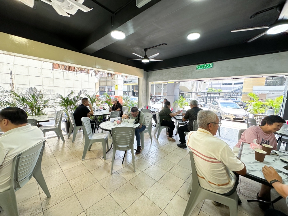 As the restaurant is located inside a corner unit, the place is airy but there's limited seats hence they line the five foot way with extra tables. — Pic by Lee Khang Yi