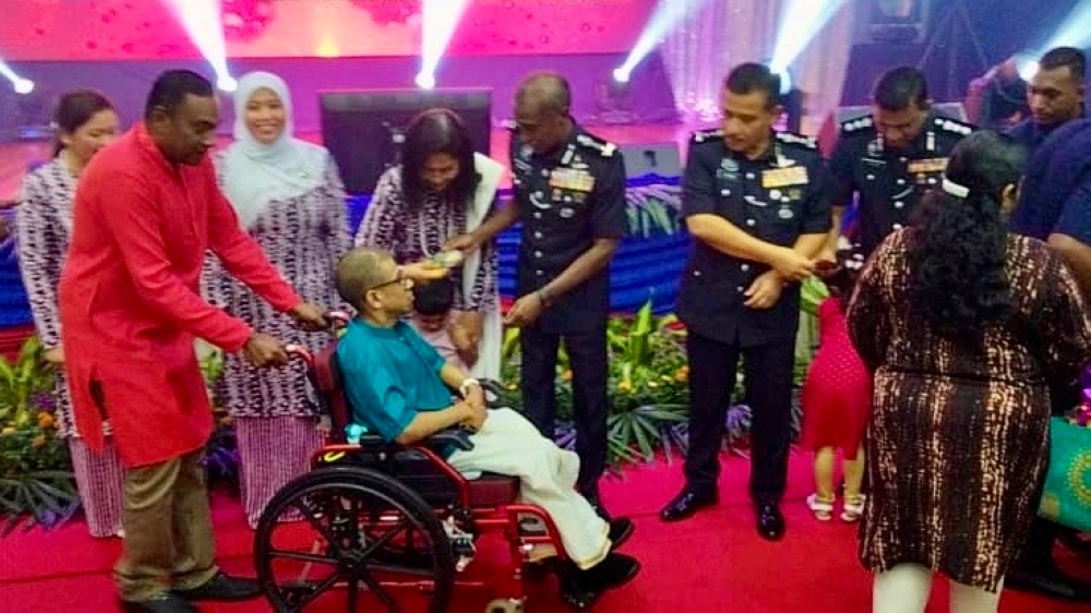 Johor police chief Datuk M. Kumar (centre) presents contributions during a programme in conjunction with Deepavali at the district police headquarters in Iskandar Puteri, on Oct 23, 2024. — Picture by Ben Tan