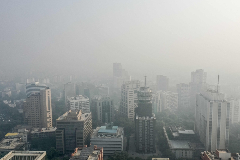 Thick smog engulfs the city skyline in New Delhi on October 23, 2024. — AFP pic