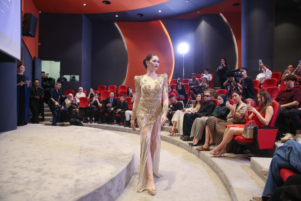 Miss Universe Malaysia Sandra Lim’s evening gown, designed by Ezuwan Ismail, is dotted with glittery stars and detailing. — Picture by Yusof Mat Isa