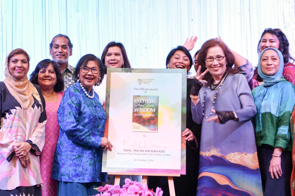 Khairy Jamaluddin (third from right) is photographed with guests during the launch of ‘Fathers and Their Wisdom’ at the Royal Lake Club in Kuala Lumpur, on Oct 22, 2024. — Bernama pic