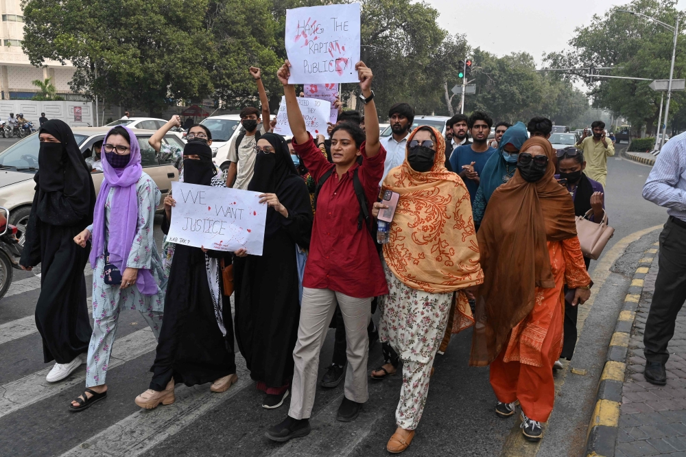 In this photograph taken October 21, 2024, students holding placards shout slogans during a protest march to condemn the alleged rape of a woman student, in Lahore. — AFP pic