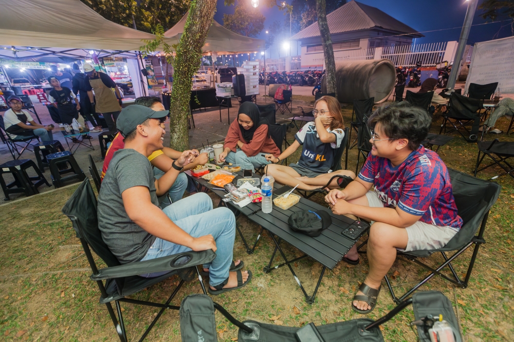 You can find many locals from different age groups spending time with their friends chilling on a healing chair at the Subang Bestari open car park space . — Picture by Raymond Manuel