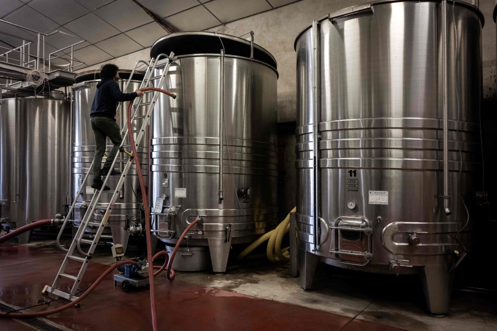 A winemaker works in the cellar of the Chateau des Chapelains winery, owned by Zhang Rong, in Saint-Andre-et-Appelles September 26, 2024. — AFP pic